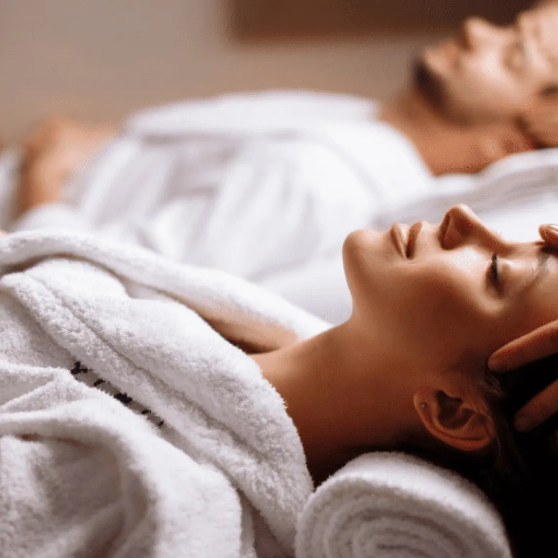 Two guests relaxing side by side after a couples massage